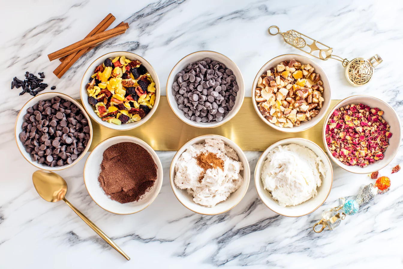 greek-yogurt-cookie-dough-customization-options- greek yogurt cookie dough with various mix-ins and toppings