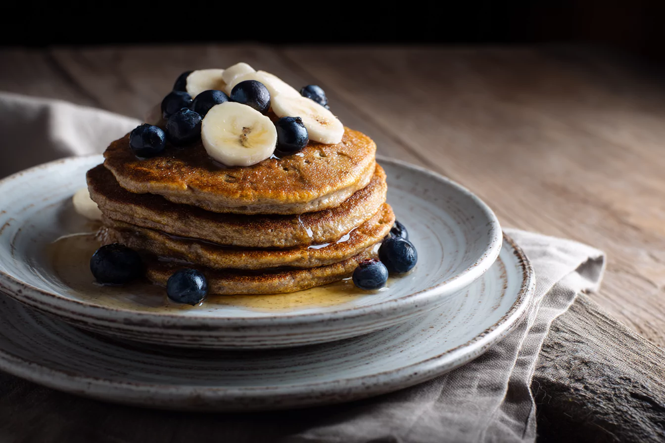 Oat and cottage cheese pancakes with banana and blueberries on a plate